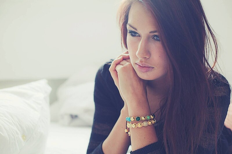 woman with bracelets on bed