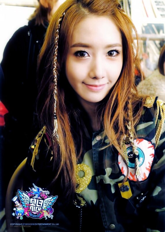 woman with braided hair and camouflage jacket