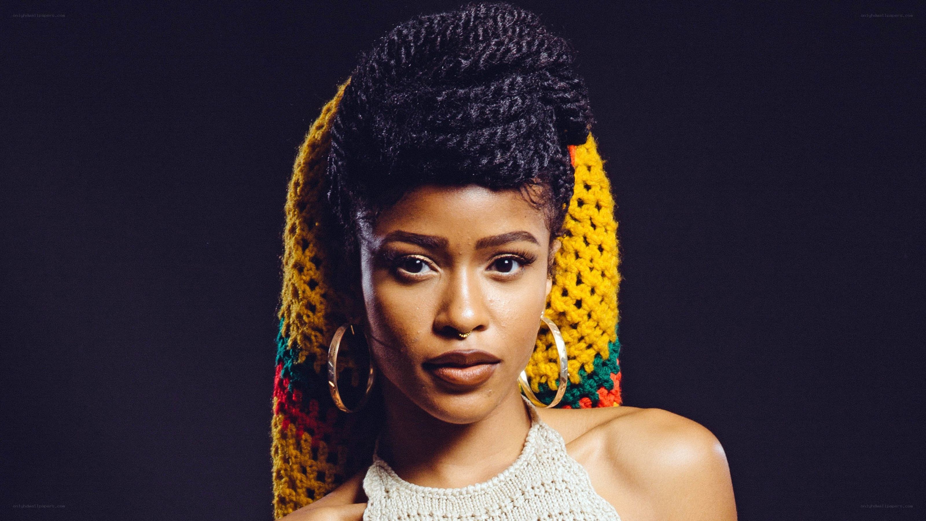 woman with braided hair and colorful headwrap