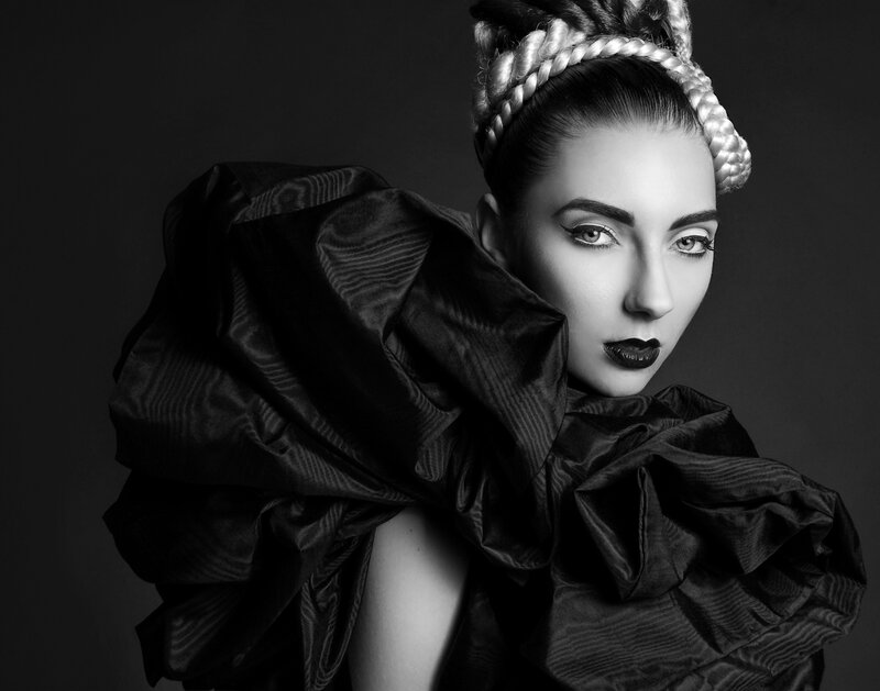 woman with braided hair and dramatic makeup