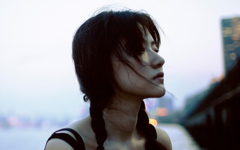 woman with braided hair in city
