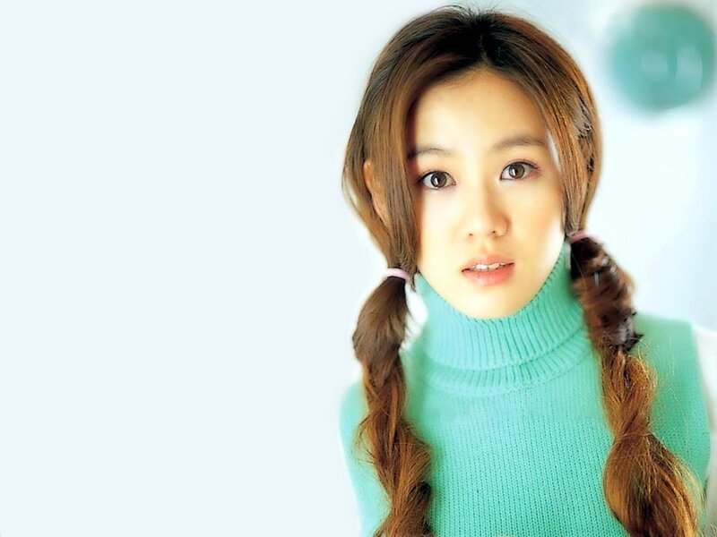 woman with braided hair in green sweater