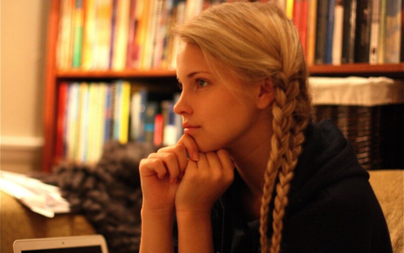 woman with braided hair in library