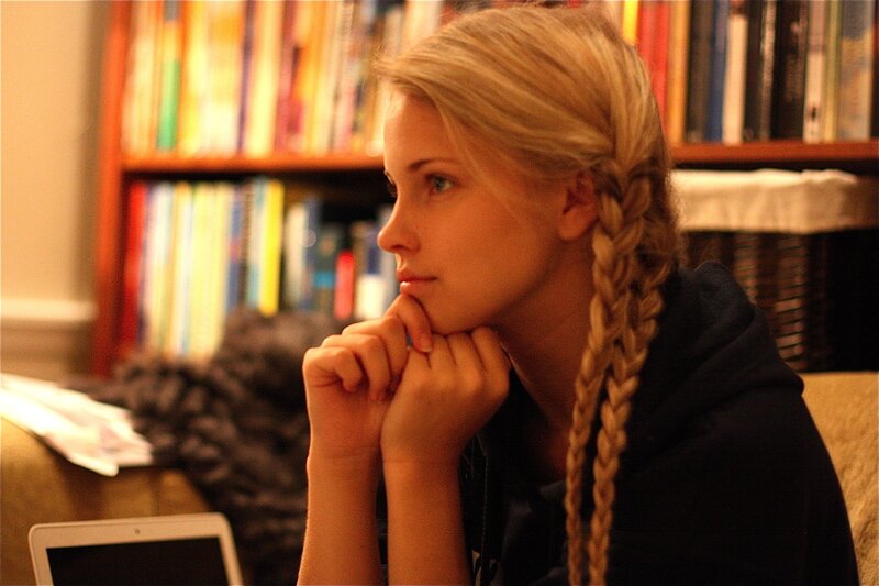 woman with braided hair in library