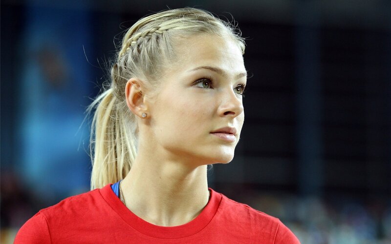 woman with braided hair in red shirt