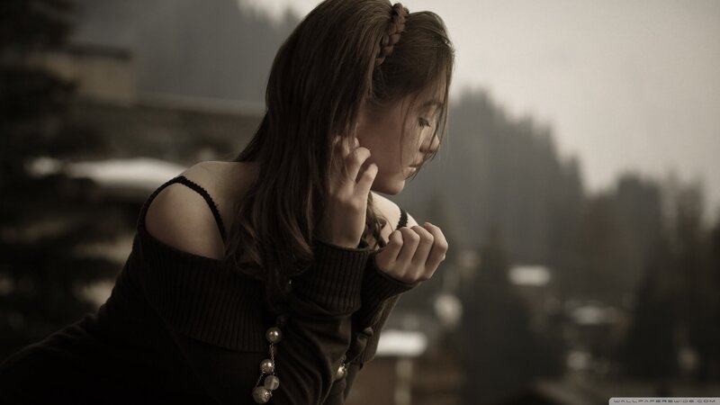 woman with braided hair looking down