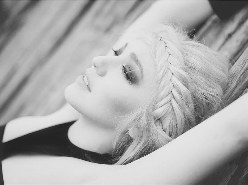 woman with braided hair lying down