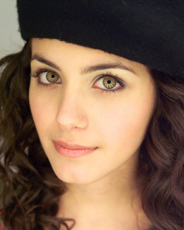 woman with brown eyes and black hat