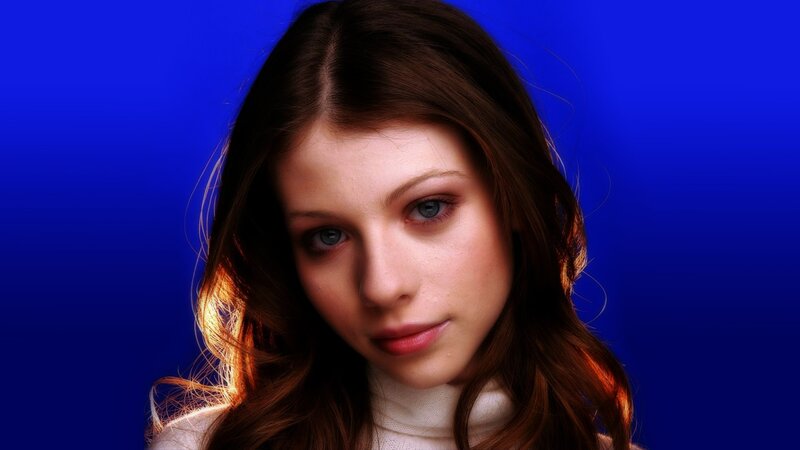 woman with brown hair against blue background