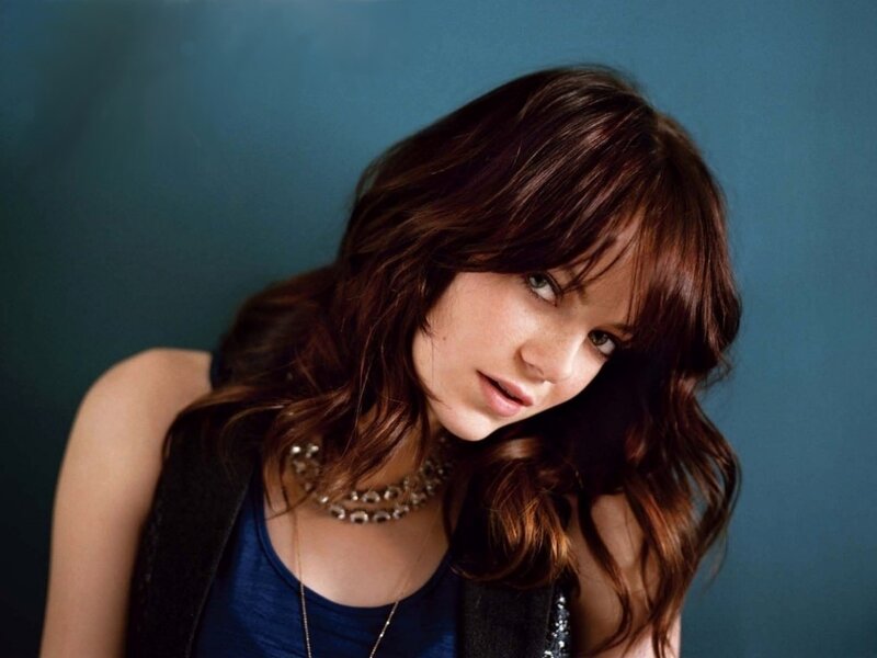 woman with brown hair and blue top
