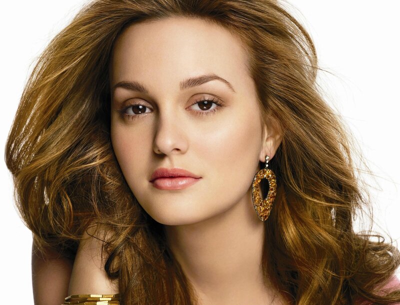 woman with brown hair and earrings