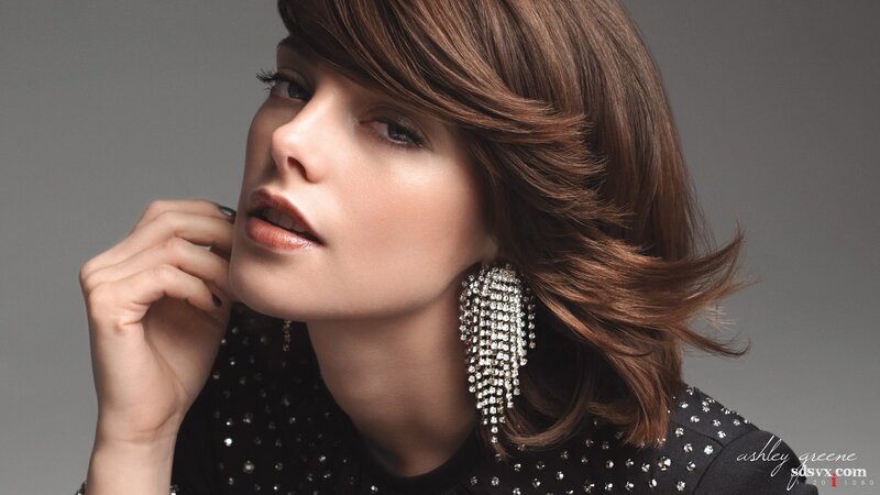 woman with brown hair and earrings