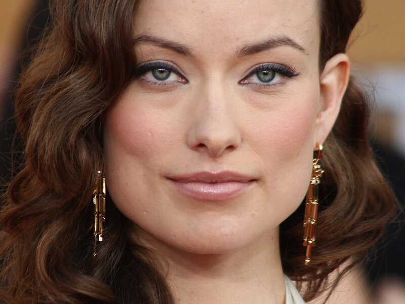 woman with brown hair and earrings