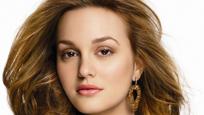 woman with brown hair and earrings