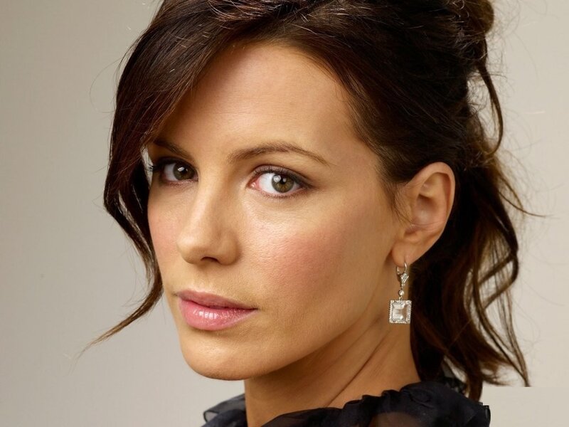 woman with brown hair and earrings