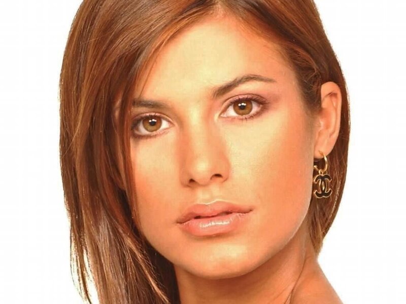 woman with brown hair and earrings