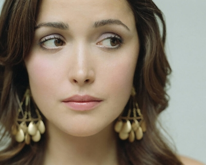 woman with brown hair and earrings
