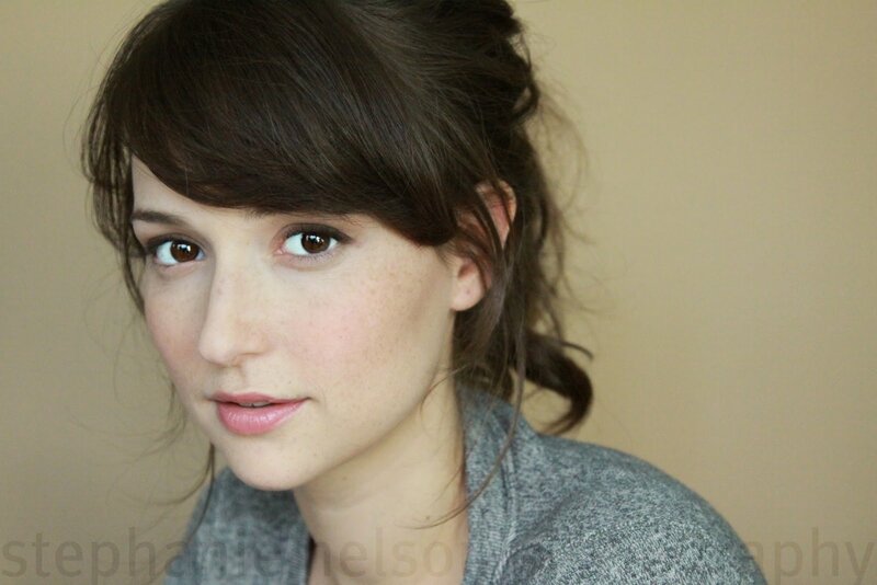 woman with brown hair and freckles
