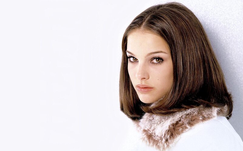 woman with brown hair and fur collar