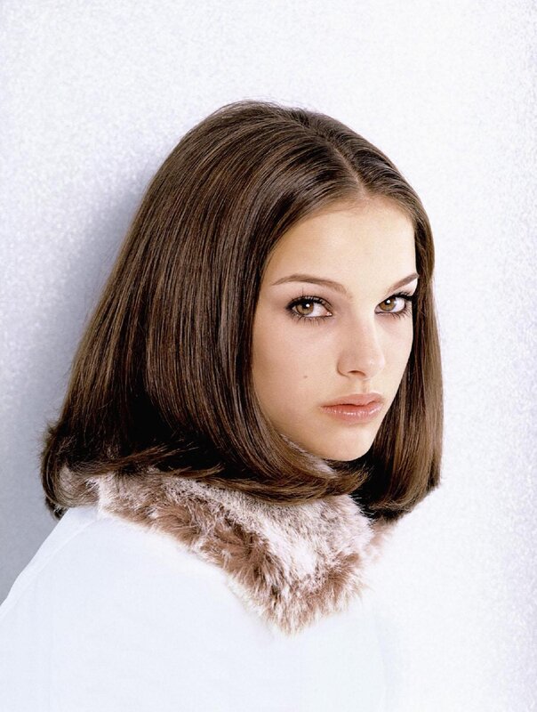 woman with brown hair and fur collar