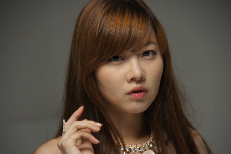 woman with brown hair and jewelry