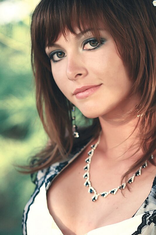 woman with brown hair and jewelry