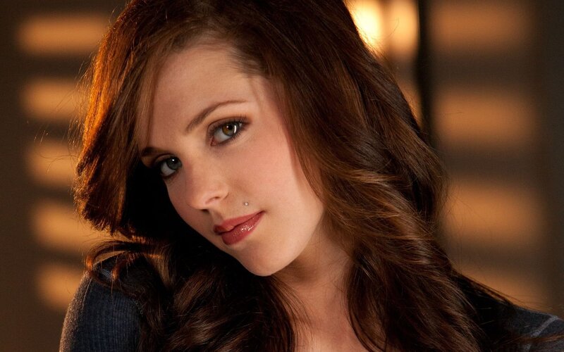 woman with brown hair and lip piercing