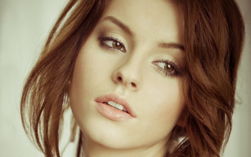 woman with brown hair and makeup