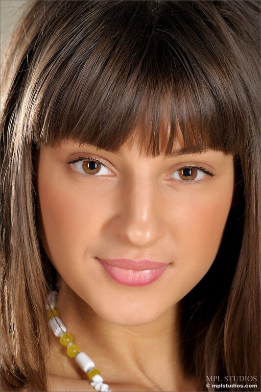 woman with brown hair and necklace