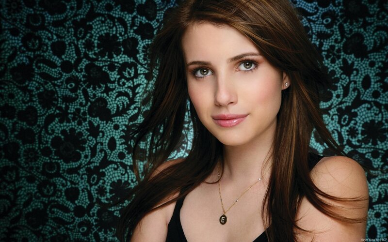 woman with brown hair and necklace