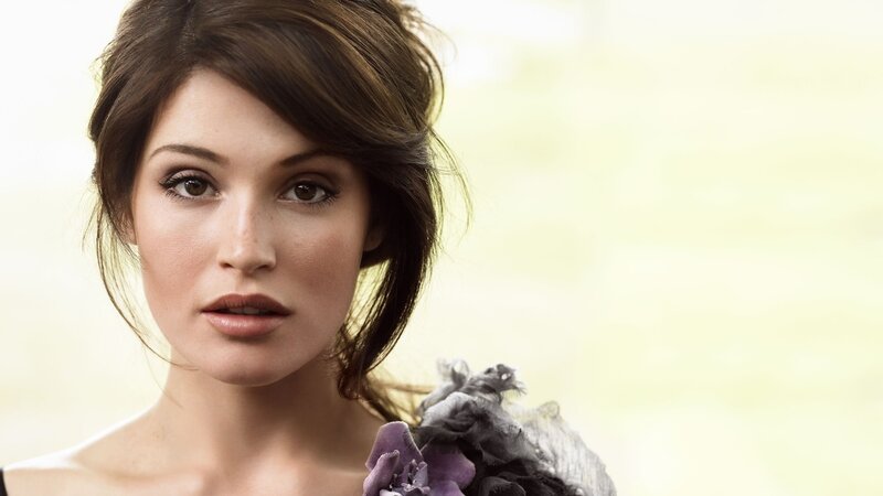 woman with brown hair and purple flowers