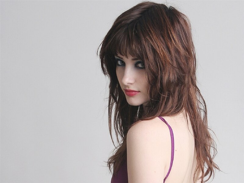 woman with brown hair and purple top