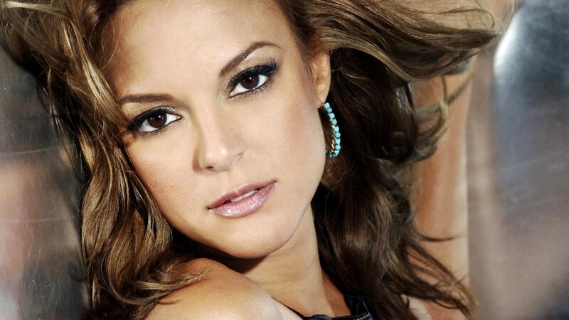 woman with brown hair and turquoise earrings