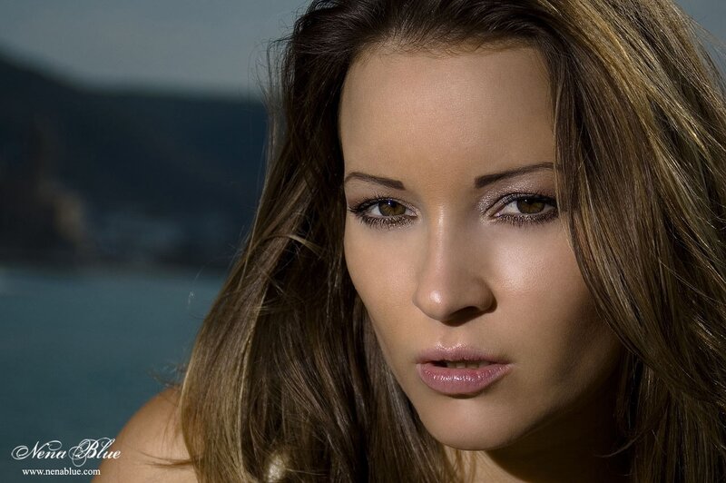 woman with brown hair by the sea
