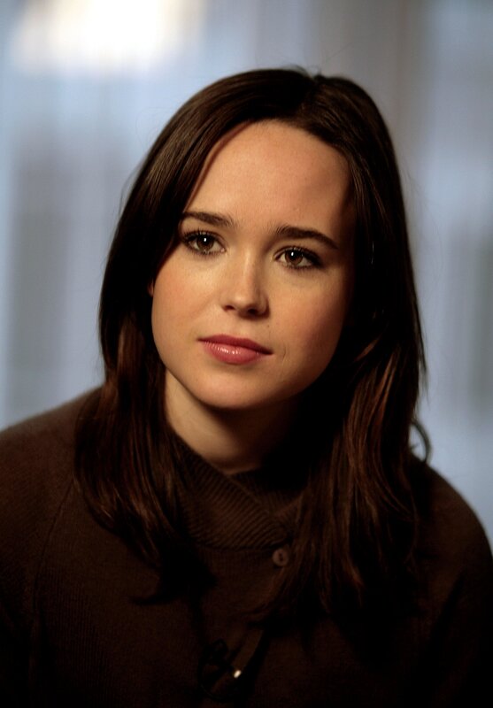 woman with brown hair in a brown sweater