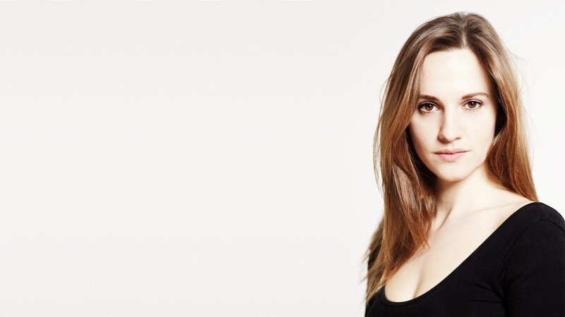 woman with brown hair in black top