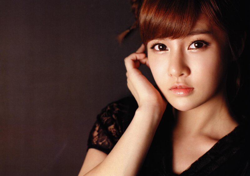 woman with brown hair in black top