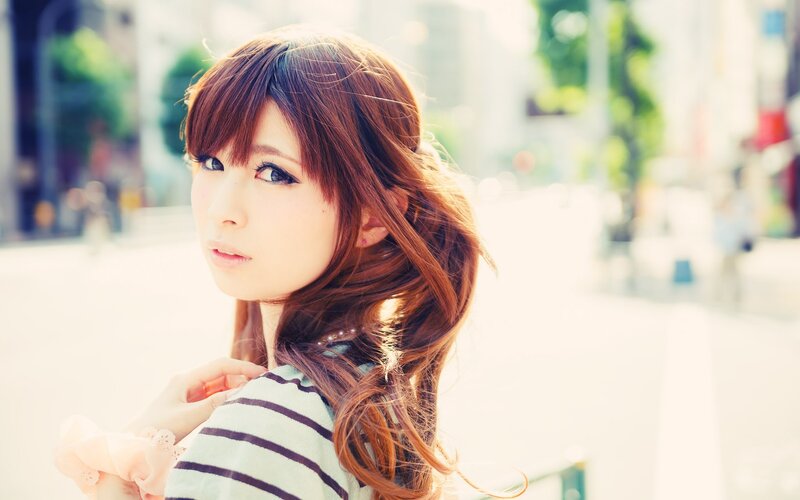 woman with brown hair in city