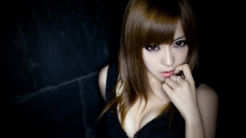 woman with brown hair in dark setting