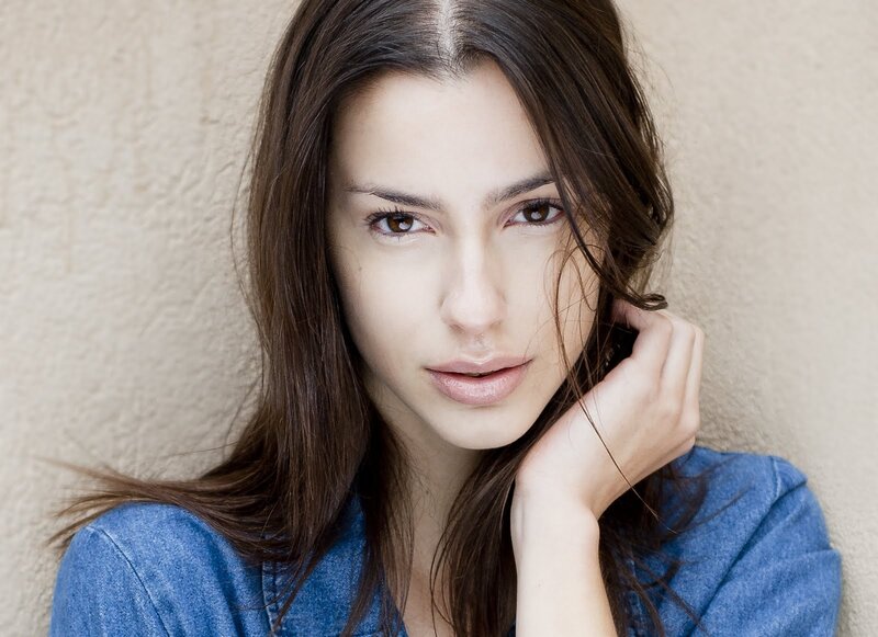 woman with brown hair in denim shirt