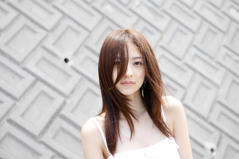 woman with brown hair in front of wall