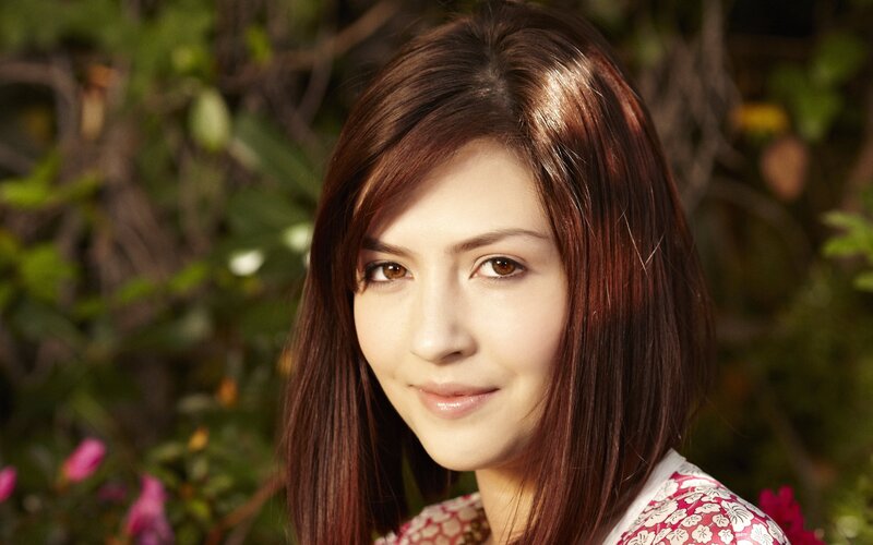 woman with brown hair in garden