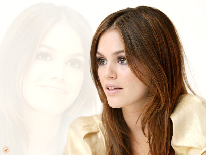 woman with brown hair in gold top