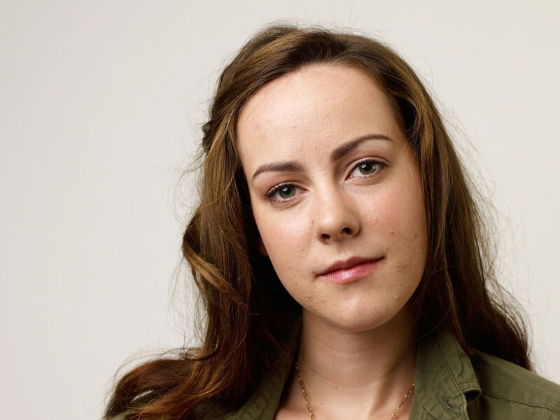 woman with brown hair in green shirt