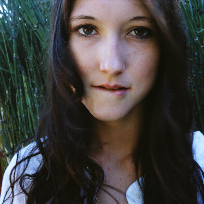 woman with brown hair in nature