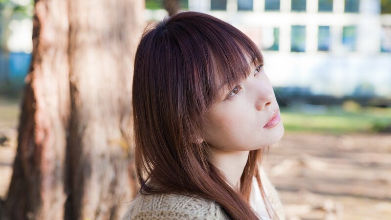 woman with brown hair in park