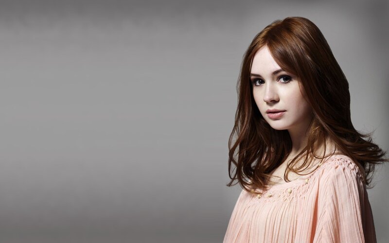 woman with brown hair in pink dress
