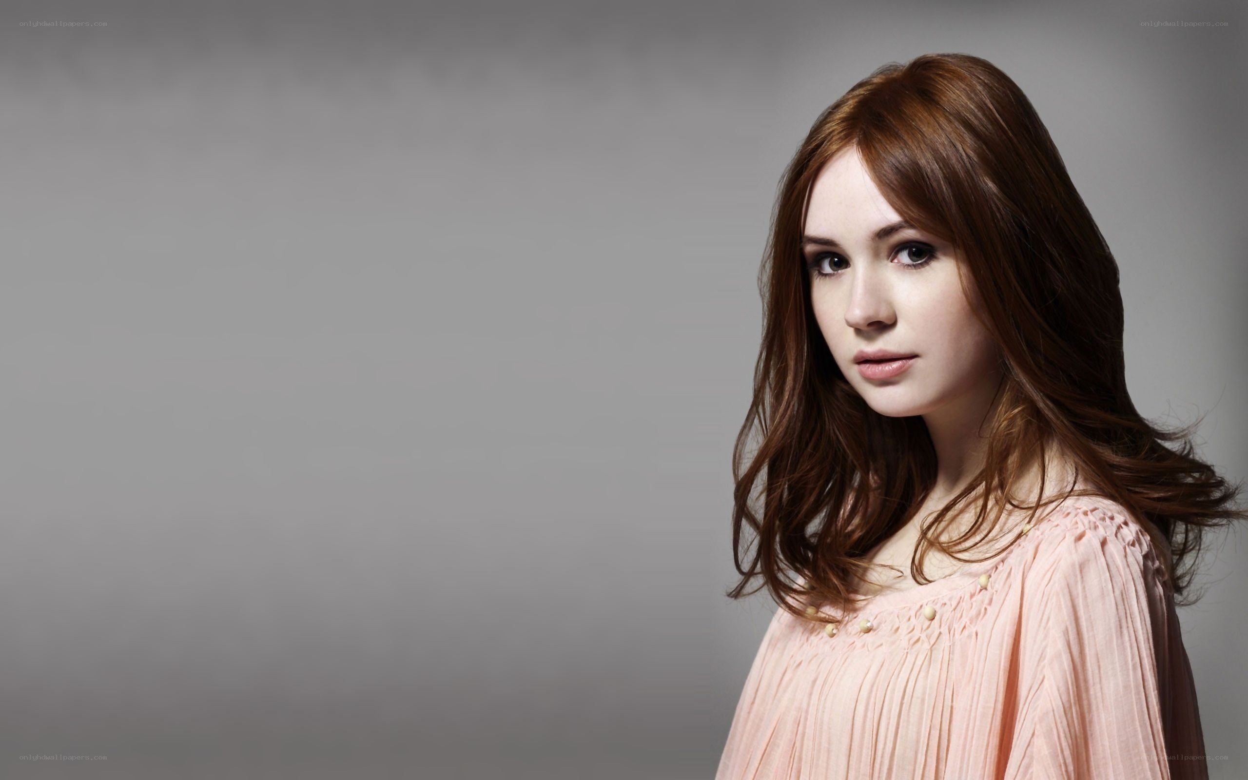 woman with brown hair in pink dress