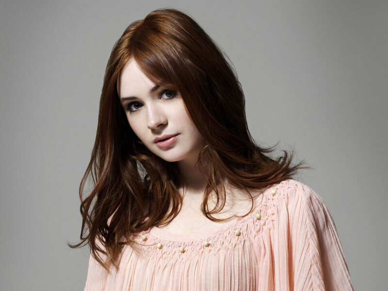 woman with brown hair in pink top