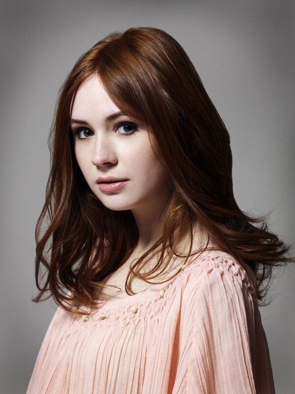 woman with brown hair in pink top